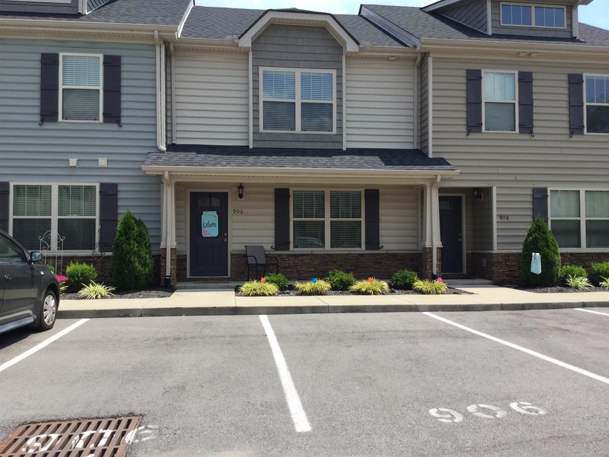 Covered porch, two assigned parking spaces & nice landscaping make this home! 