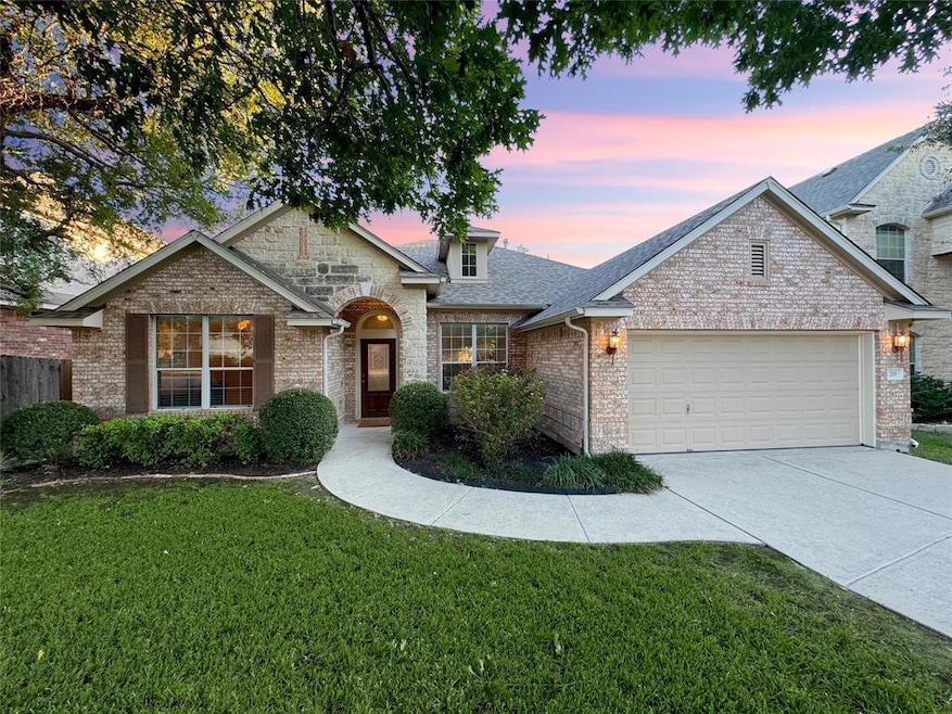 View of front of property with a garage, driveway