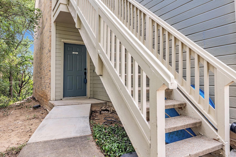 Entrance to property featuring brick siding