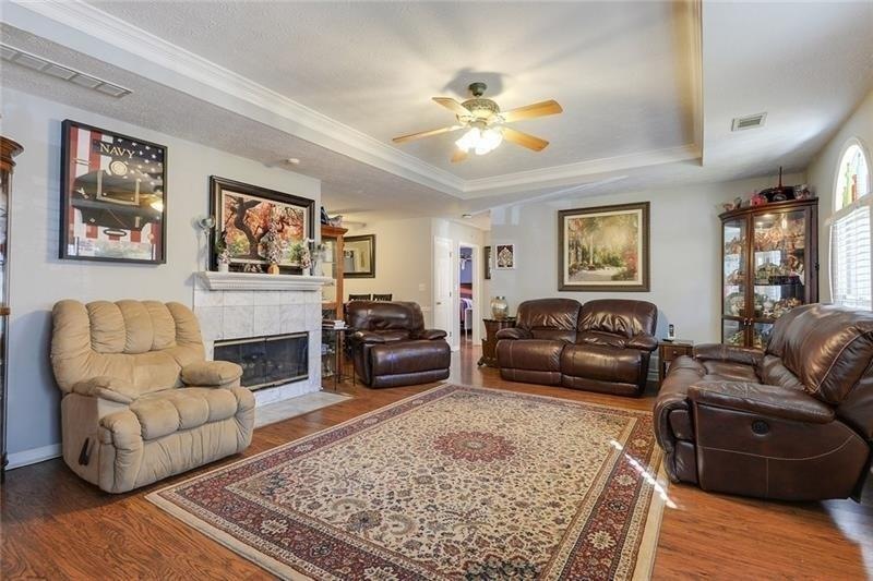 Warm, inviting family room with fireplace. No carp