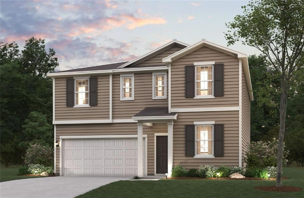 View of front of house featuring a yard and a gara