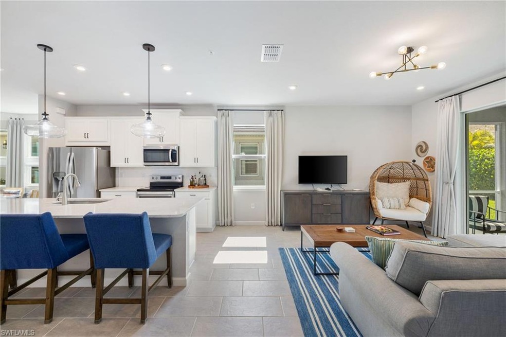 Living room with recessed lighting, a chandelier, and light tile patterned floors