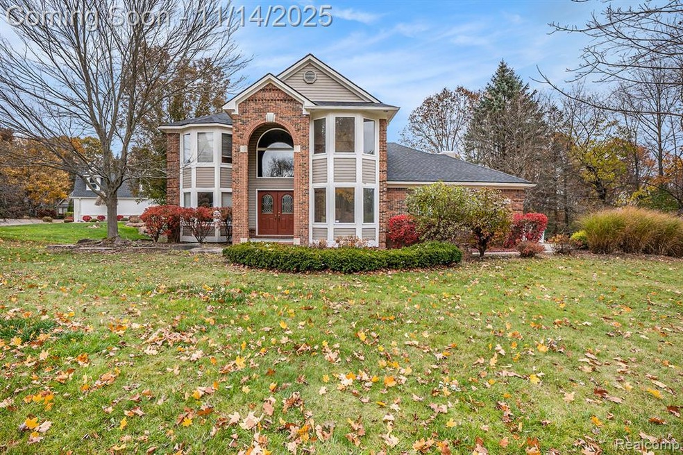 View of front facade featuring brick siding and a front yard