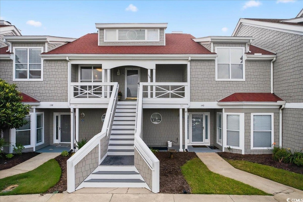 View of front facade featuring stairs, a shingled roof, and covered porch