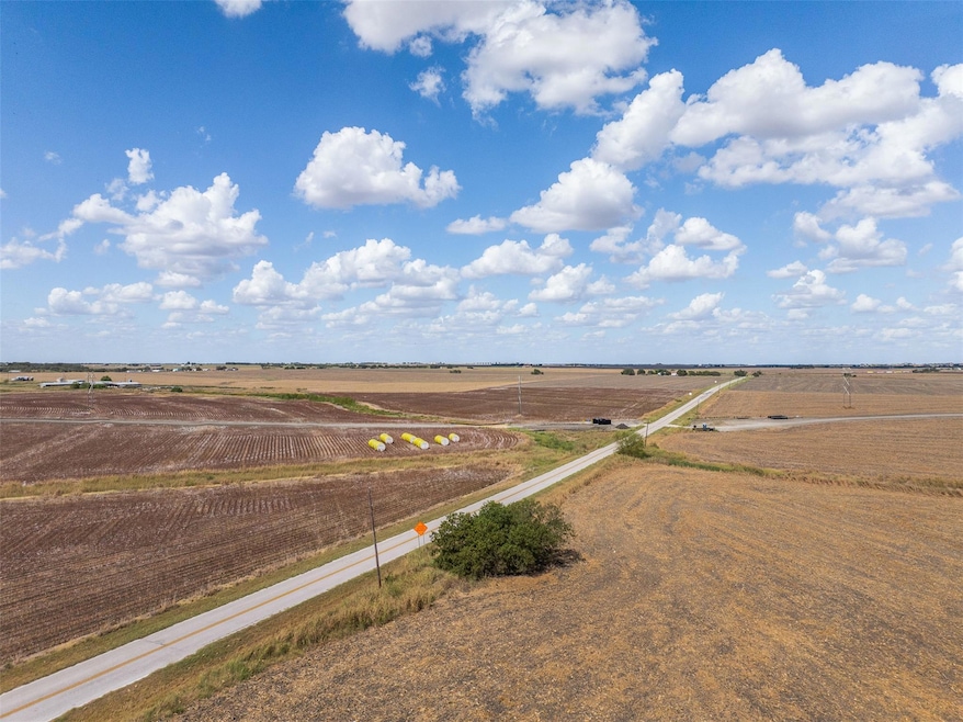 Aerial view of sparsely populated area featuring large plots for crops