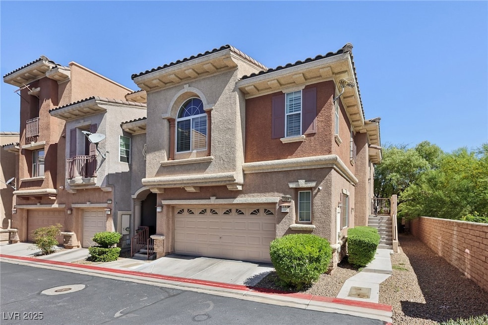 Mediterranean / spanish-style home featuring an attached garage, stucco siding, and concrete driveway