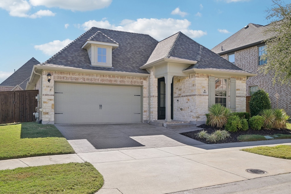 French country inspired featuring stone, concrete driveway, a shingled roof, and an attached garage