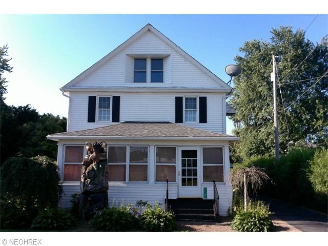 Front of the house showing the enclosed porch, woo