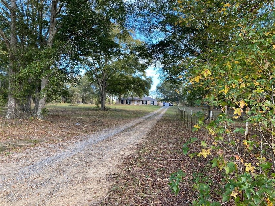 This updated home sits off the road and offers acr