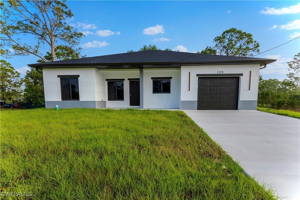 View of front of property with a front lawn, stucc