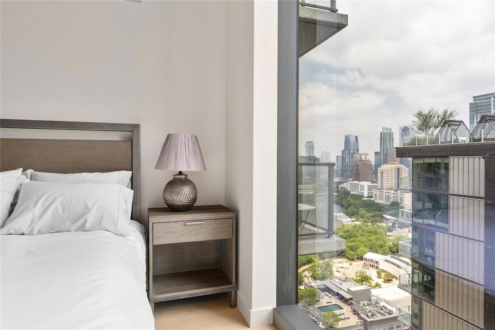 Bedroom featuring baseboards and a city view