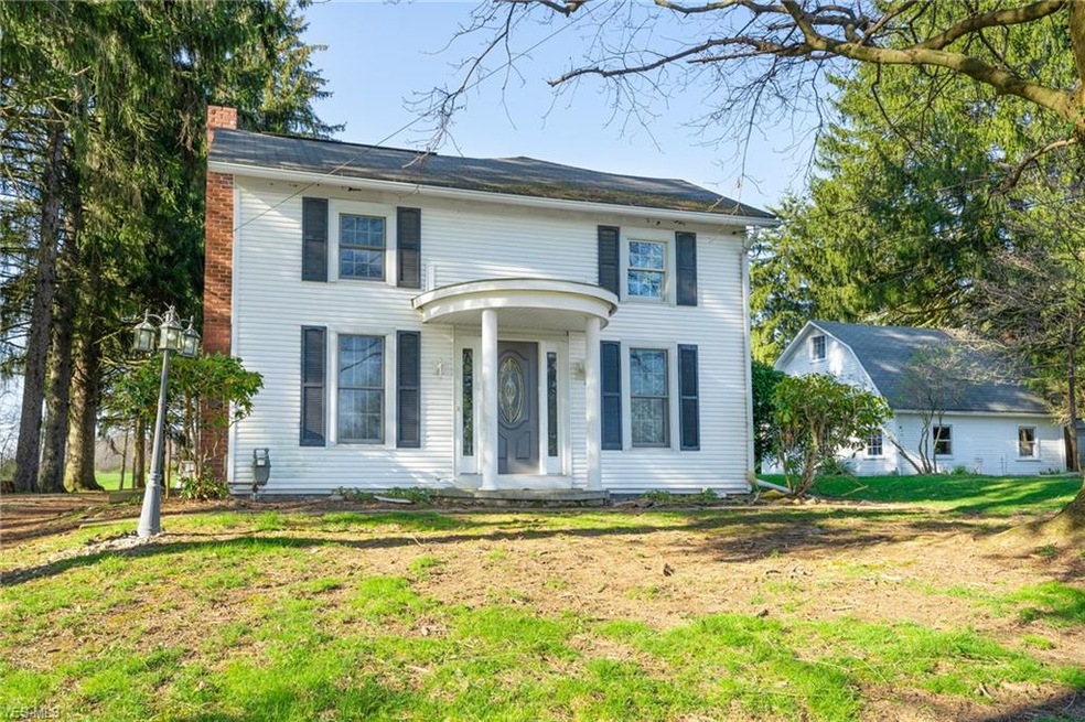 Very front of home, with a small barn to the right