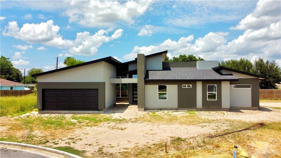 View of front of property featuring stucco siding and an attached garage