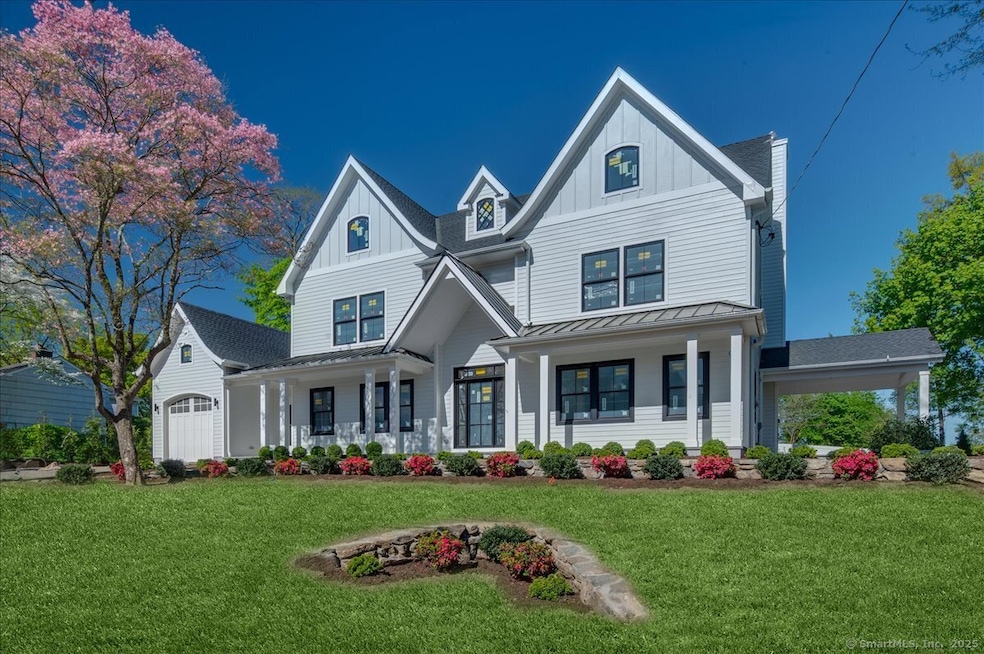 Beautifully landscaped with White James Hardie siding