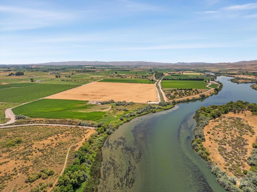 Aerial view of sparsely populated area featuring a water and mountain view