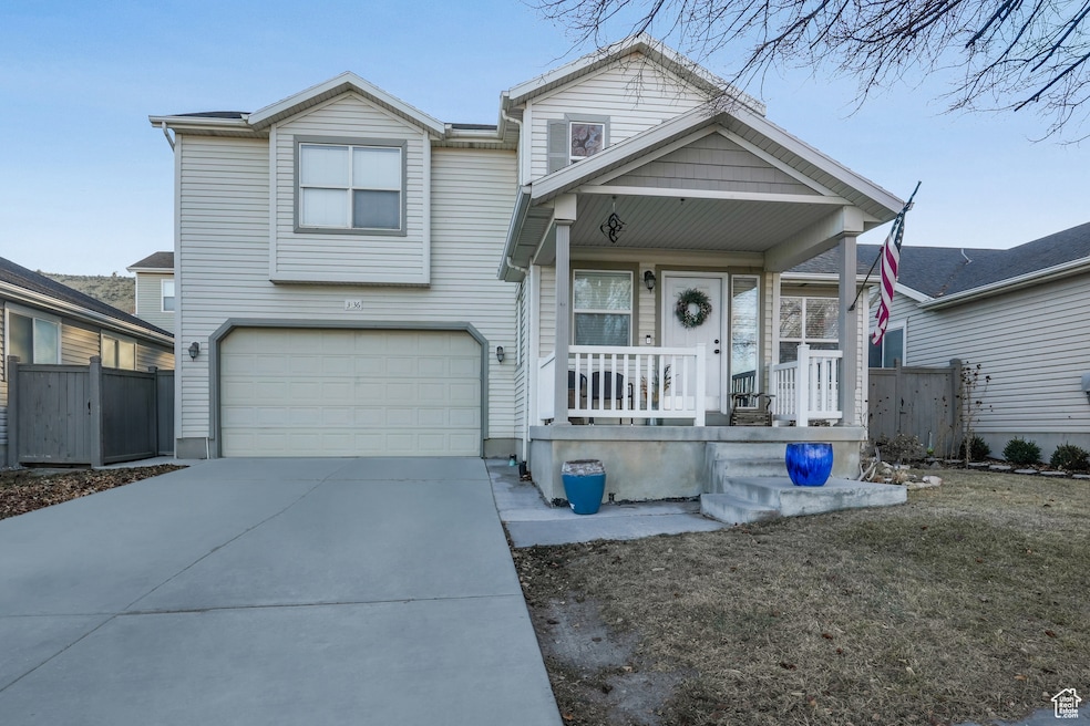 View of front of home with a garage and covered porch