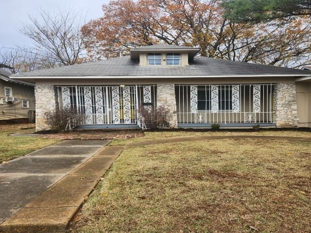 View of front of property with a porch, a front ya