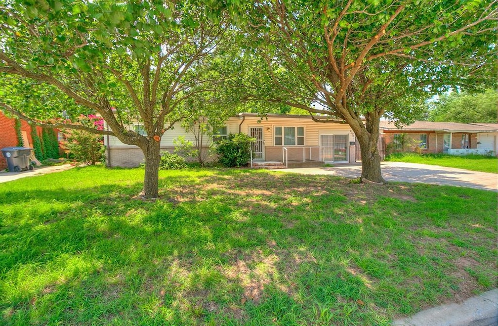 Ranch-style house with concrete driveway and a front yard