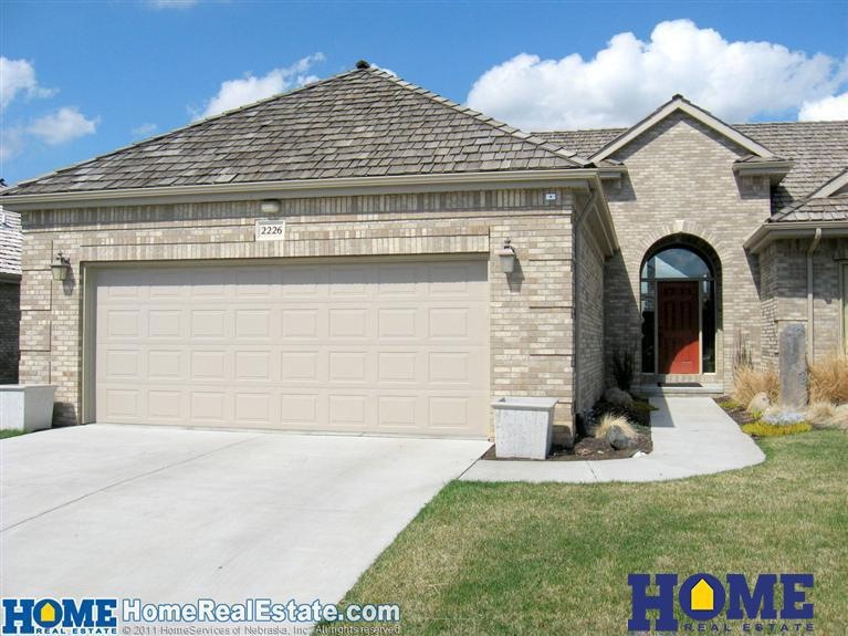 2226 Stone Creek Loop North. All brick, maintenance free construction with walkout, daylight basement 3 bedrooms, 2 fireplaces. DELUXE!