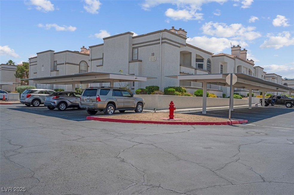 Partially covered parking lot featuring a residential view