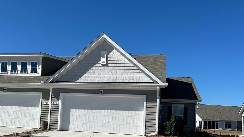 View of front facade with driveway and a garage
