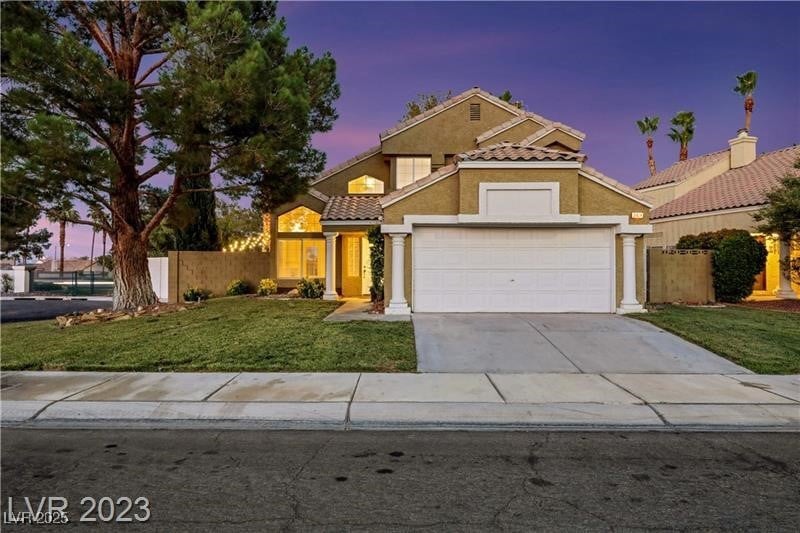 View of front of house featuring fence, driveway,