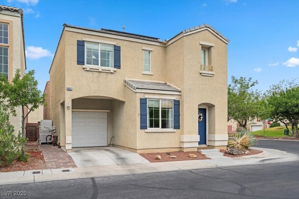 View of front of house featuring a garage, stucco siding, driveway, and a tile roof
