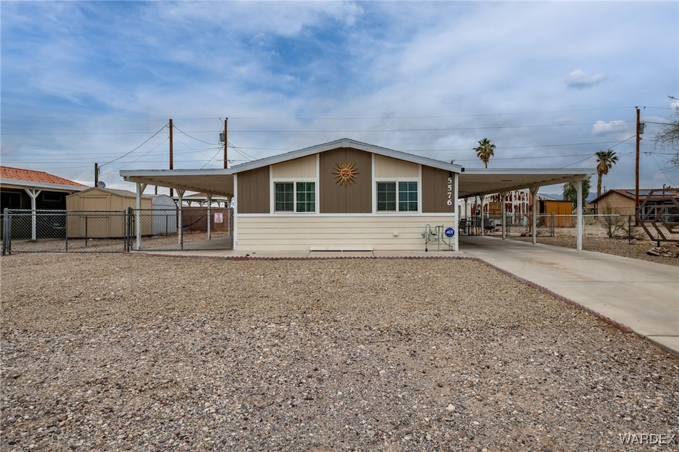 View of front of home featuring a gate, an attache