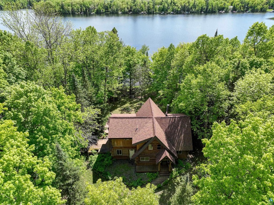Birds eye view of property with a water view