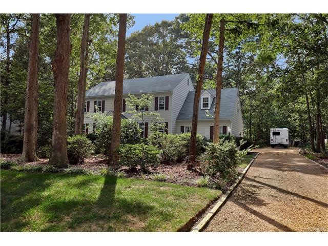 Large landscaped yard with huge parking pad in the