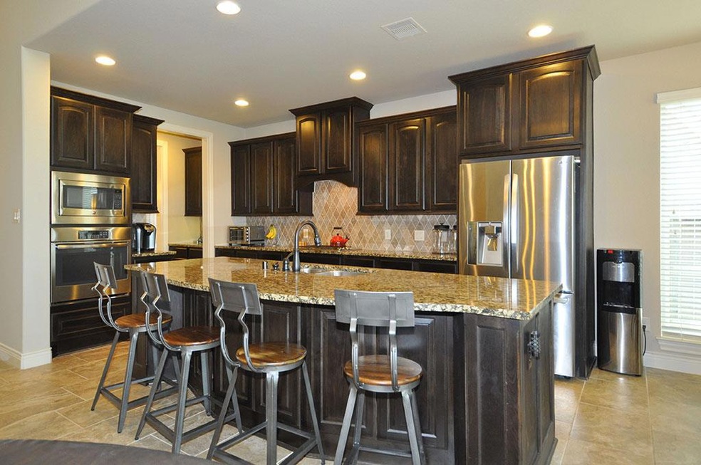 This inviting kitchen is just the beginning of one of the many  comforts of home featured in this pristine open floor plan.  Available in time for the start of  KISD s Fall semester!