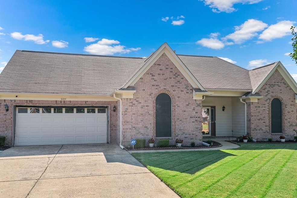 View of front of house with a front yard and a gar
