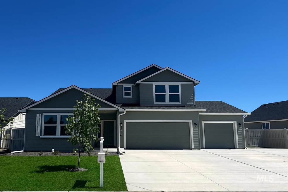 View of front of house featuring driveway, a garage, and roof with shingles