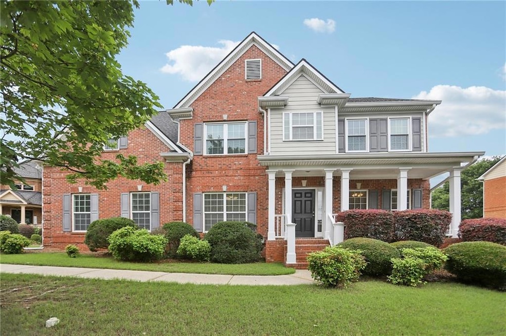 View of front facade with a front yard and brick siding