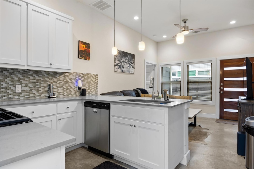 Kitchen with stainless steel dishwasher, a penins
