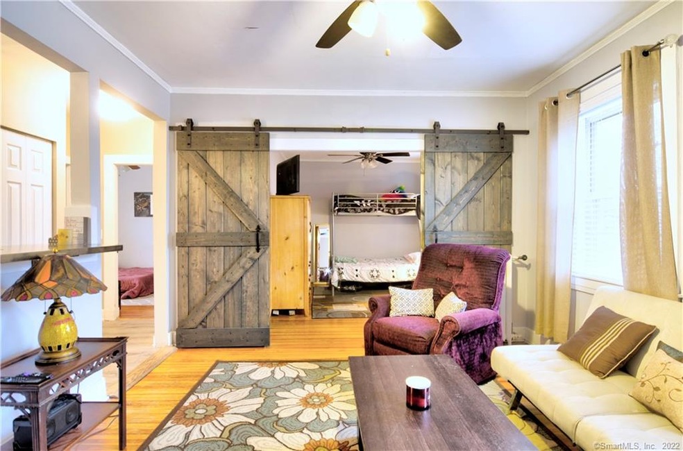 Living room with hardwood floors and barn door sli