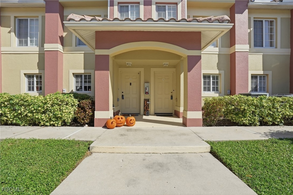 Entrance to property with a tile roof and stucco siding