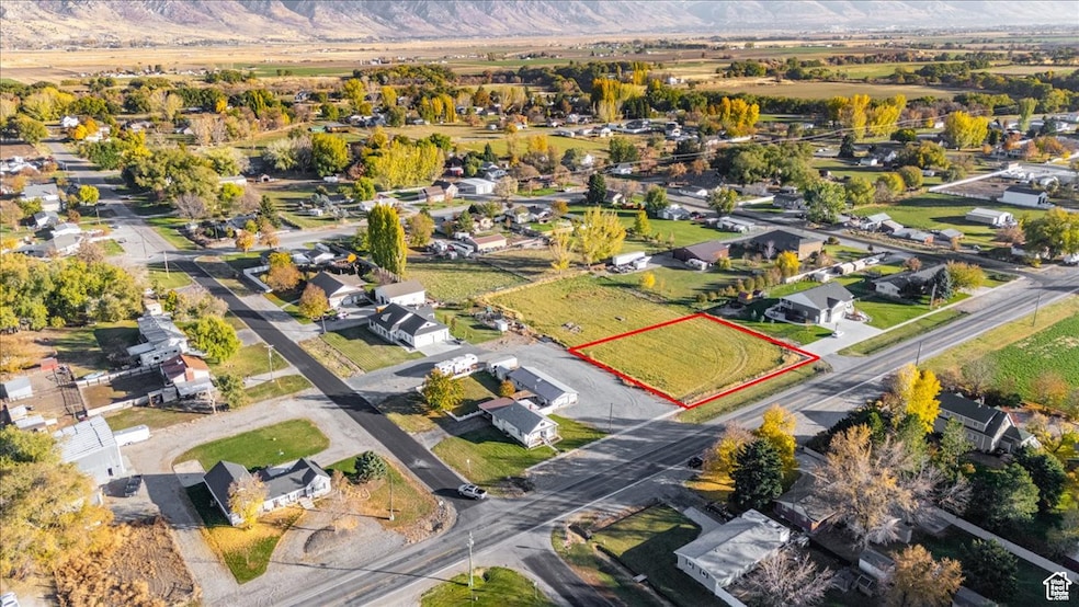 Aerial view of residential area featuring property boundaries highlighted and mountains