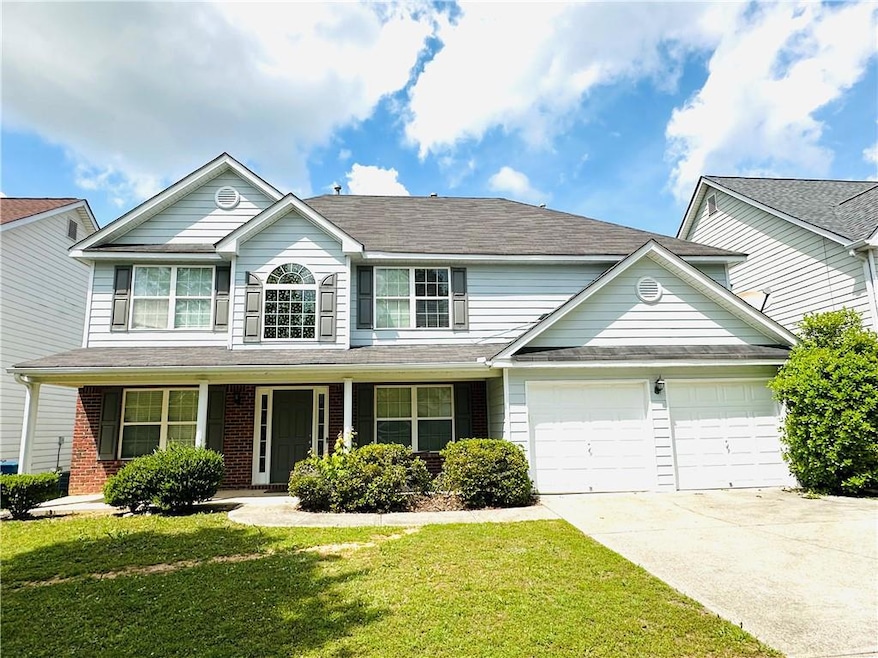 Traditional-style home featuring brick siding, dri