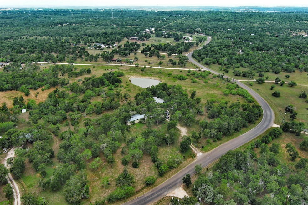 Aerial overview of property's location with a heavily wooded area