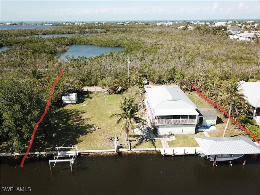 Birds eye view of property with a water view