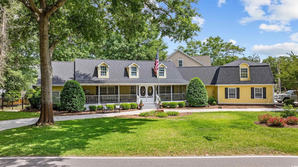 Cape cod house featuring a porch, a shingled roof,