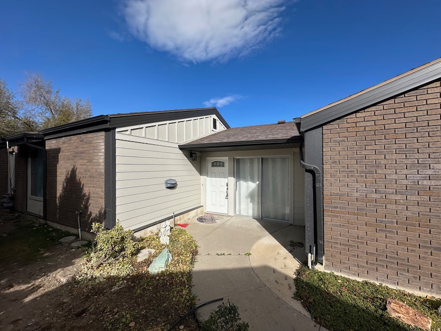 Entrance to property featuring brick siding and board and batten siding