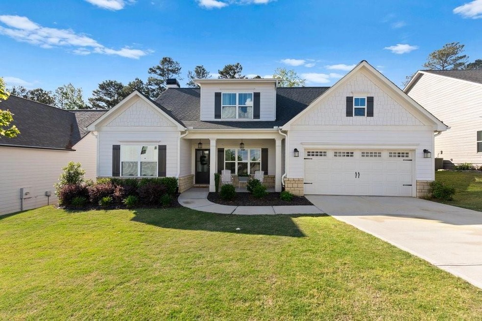 Craftsman-style home with a front yard, a garage, 