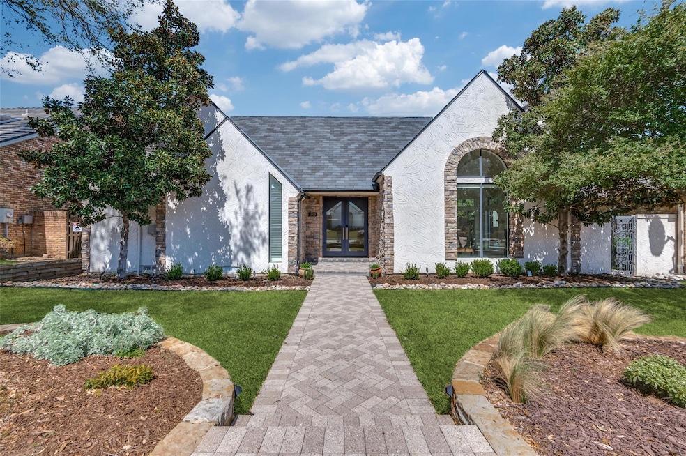 View of front facade with a front lawn, stucco sid