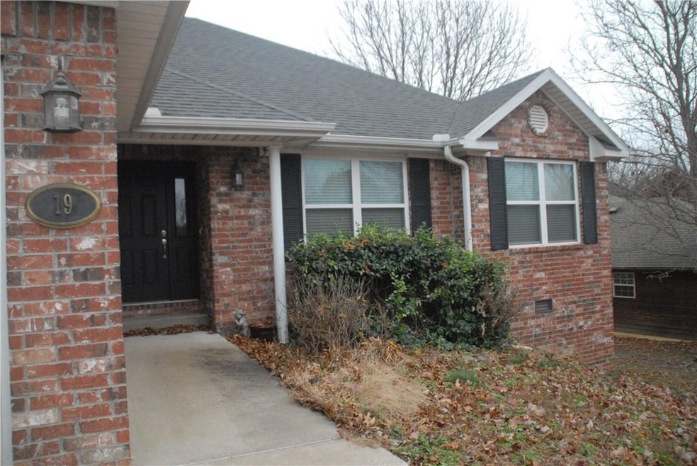 Nice covered entry and sculpted planter bed.