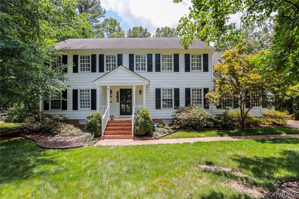 Colonial home featuring covered porch and a front