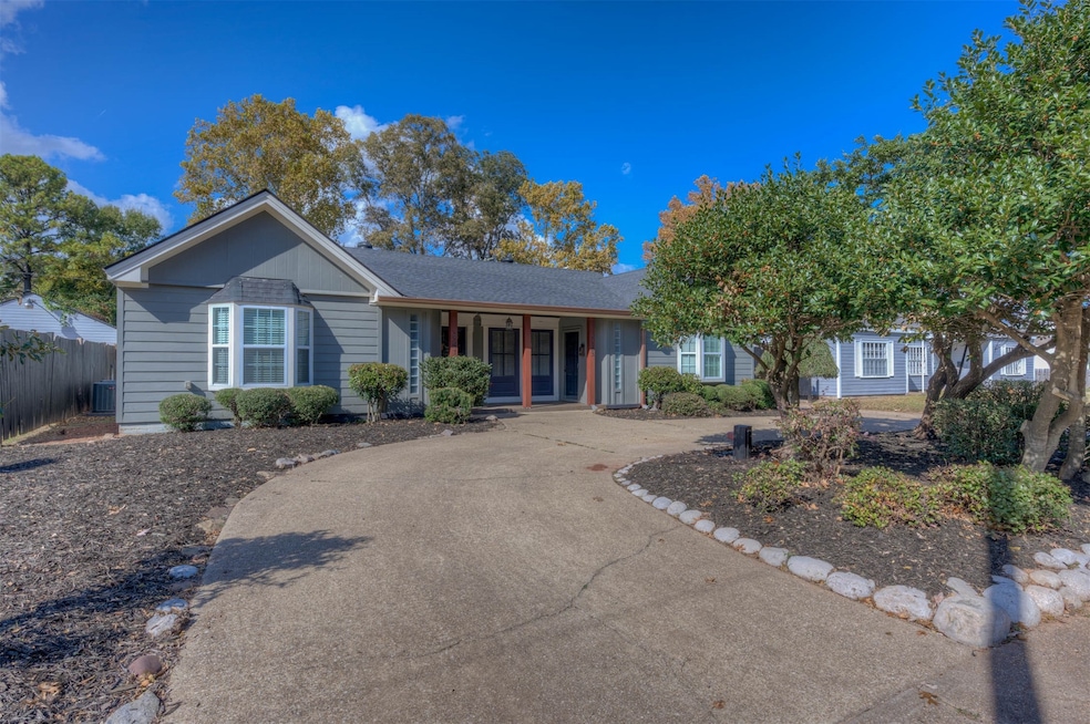 Single story home featuring covered porch and a shingled roof