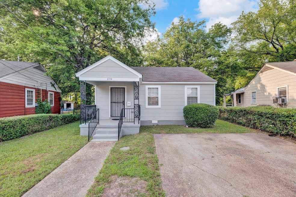 View of front facade featuring a front lawn, a porch, a shingled roof, and crawl space
