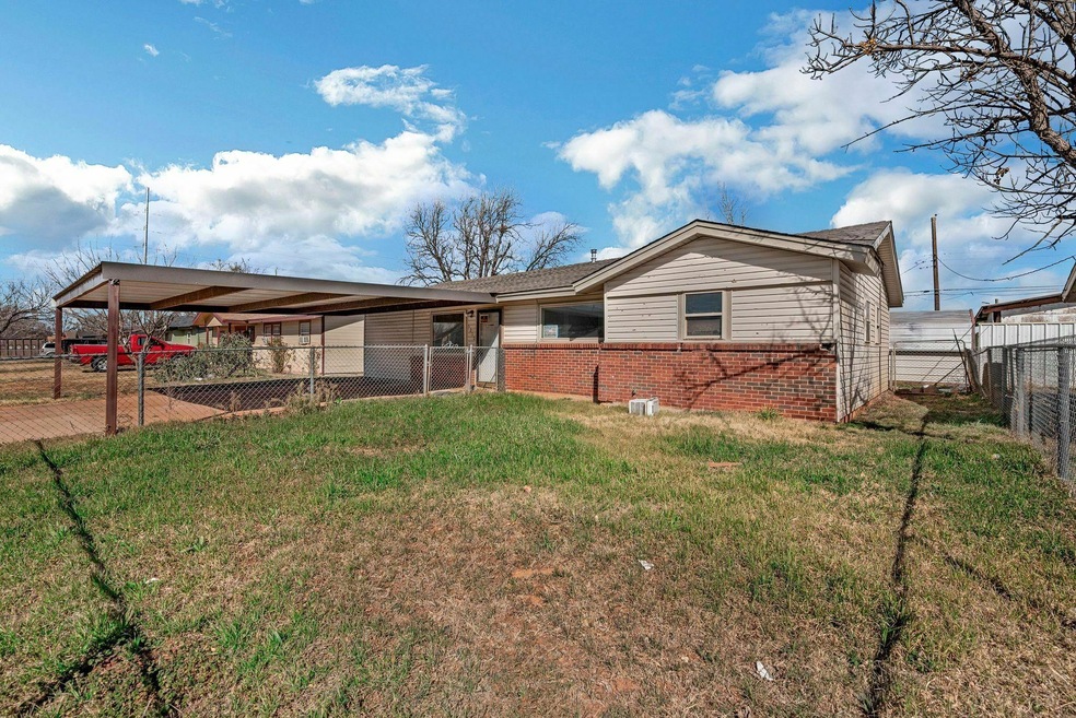 View of front facade featuring brick siding, fence